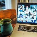 macbook pro displaying group of people; Manage Remote Teams