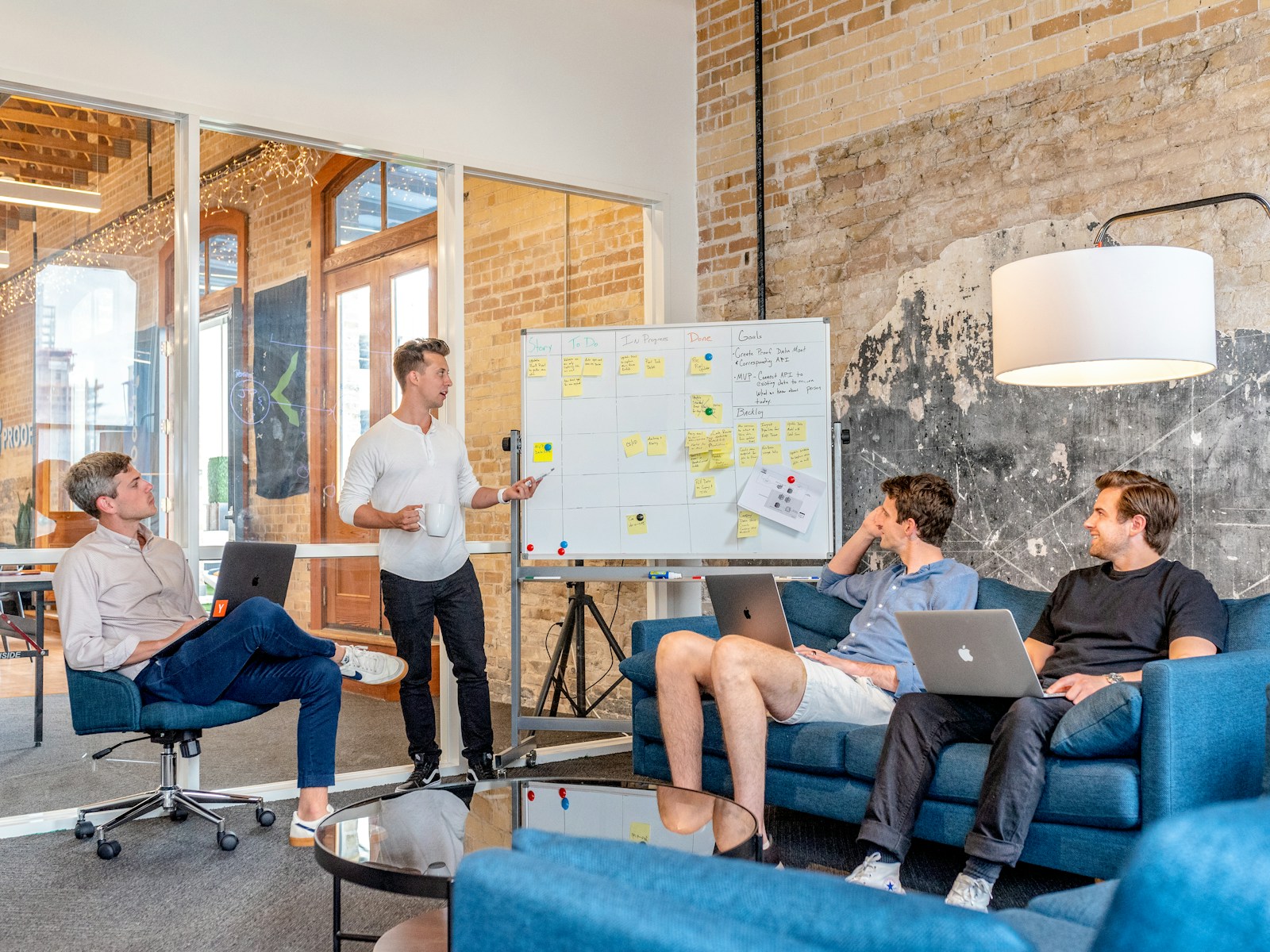 three men sitting while using laptops and watching man beside whiteboard; confident founder lessons