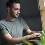 Image of a founder typing business idea on a laptop; follow passion dangerous advice