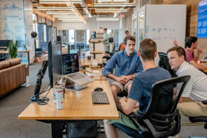 Entrepreneurs sitting in open workspace discussing strategy; entrepreneurial mindset corporate burnout