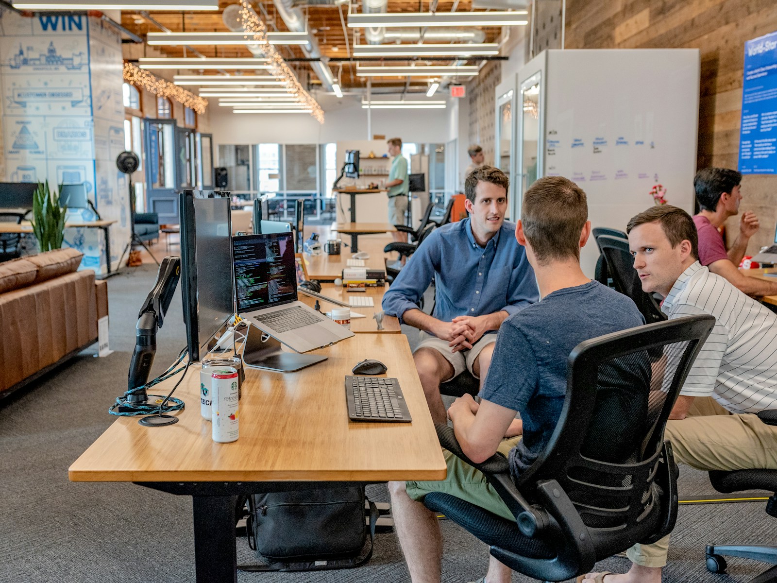 Entrepreneurs sitting in open workspace discussing strategy; entrepreneurial mindset corporate burnout