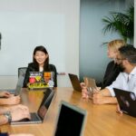People in a meeting discussing app development; emotional honesty advantage
