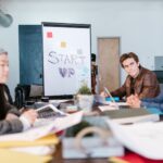 A group of young professionals brainstorming ideas in a startup office setting; gen z entrepreneurs