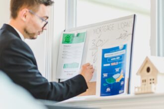 Real estate agent analyzing mortgage loan details on a whiteboard in an office setting; mortgage automation
